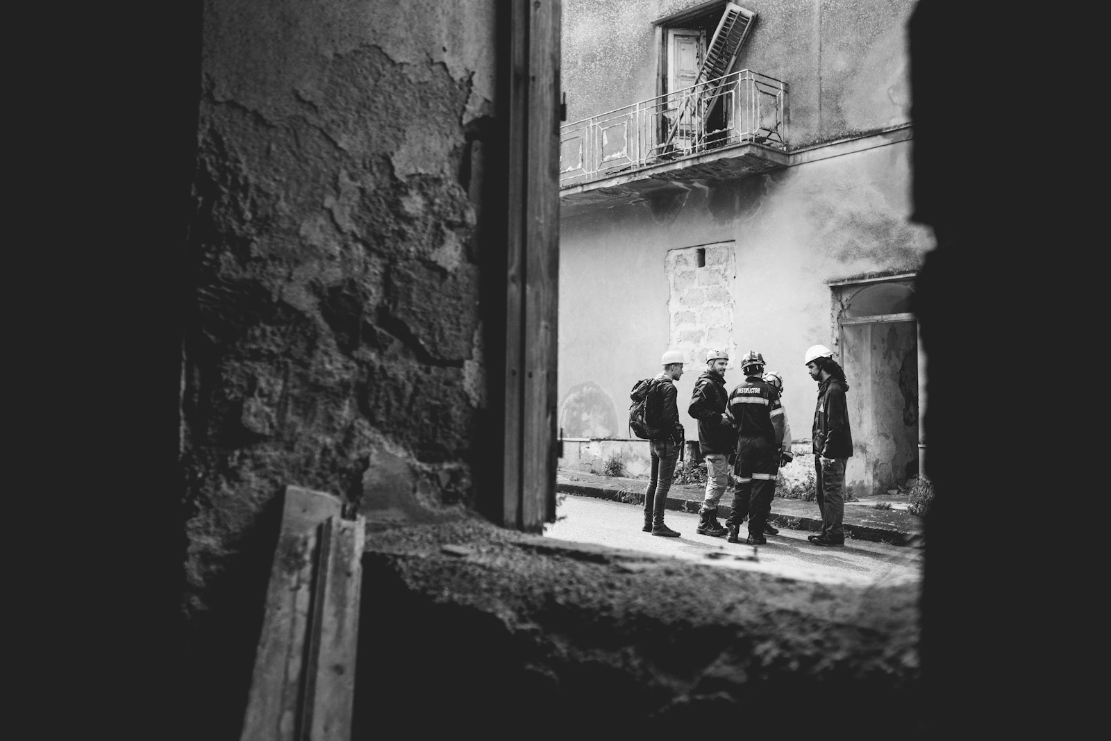 grayscale photo of 2 men walking on street